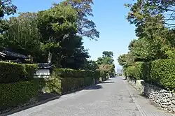 Small street lined with low stone walls.