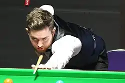 Jak Jones playing a shot