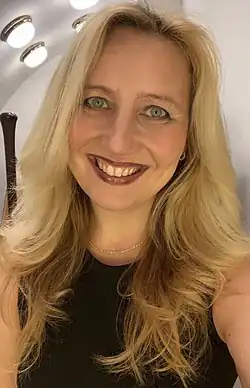 Jana Boušková wearing a short-sleeved black top, grinning at camera