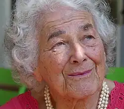 A photograph of a woman looking up and to the right