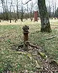 Hydrant from the former Husum-Schwesing sub-camp (with steles in the background)