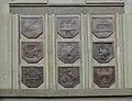 A cartouche with the voivodeship coat of arms on the north side of the building.