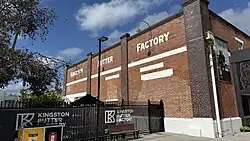 A 1930s brick building with white painted lettering