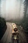 Logging trucks move through park from cutting near park boundary