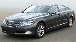 Angled forward view of sedan parked outdoors.