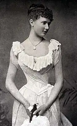 Scoop neck ballgowns, like this 1896 gown with ruffle-trimmed neckline, have been popular since the Renaissance.