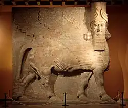 Stone sculpture of human-headed winged bull from Neo-Assyrian period.