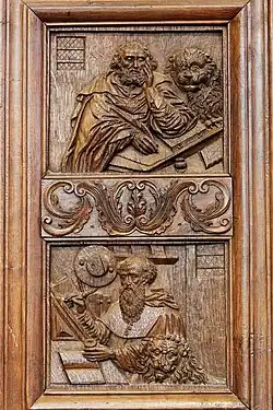 In the top panel Mark the Evangelist is accompanied by his attribute, the lion. In the panel below Saint Jerome is shown, also with a lion. Jerome is often depicted with a lion, in reference to the popular hagiographical belief that he had tamed a lion in the wilderness by healing its paw.