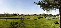 Panoramic photo of a green racetrack.