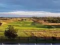 the 18th at Granville seen from the cluhouse at sunrise when the shadows play on the humps and hollows