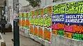 Wall covered with bright, colorful concert posters