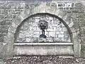Phallic graffiti under a relief of a lion, Kingswood Estate, 2025