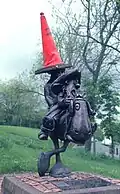 The statue, sporting a traffic cone.