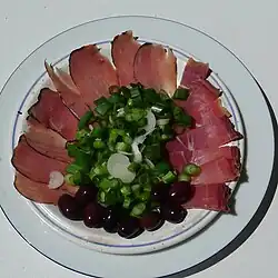 Meat meze with sliced lountza, chiromeri, onions and olives