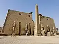 Entrance of the Luxor Temple, western façade; a pair of obelisks usually stood in front of a pylon; the 2nd obelisk (the Luxor Obelisk, 23 metres (75&nbsp;ft) high, not shown) was moved in the 1830s to the Place de la Concorde in France.