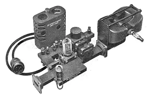 Transmitter assembly of a 20&nbsp;kW, 9.375&nbsp;GHz air traffic control radar, 1947. The magnetron tube mounted between two magnets (right) produces microwaves which pass from the aperture (left) into a waveguide which conducts them to the dish antenna.