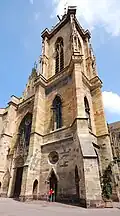 Façade and steeple. Note the unusual, massive supporting pillars