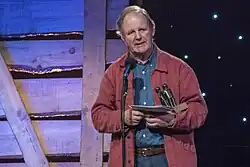 Michael Morpurgo on stage accepting an award.
