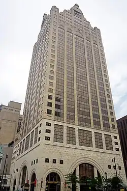 100 East Wisconsin rises tall with several other buildings visible along the river.