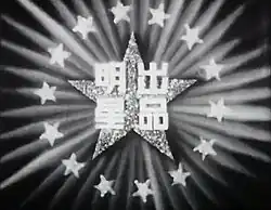 A large star with four Chinese characters on it, surrounded by bursts of light and several smaller stars