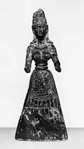 Baltimore stone figure, probably a fake, pre-1929. A snake winds round the headdress and the hands are pierced as if to hold snakes.