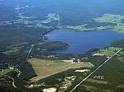 Airfield Mohed and the surrounding village Mohed in the foreground, with lake Florsjön in the background.
