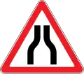Road narrows on both sides