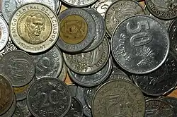 A pile of various silver and bronze colored coins