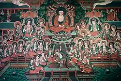Mural depicting a Buddha and two Bodhisattvas seated on lotus thrones, with multiple other Bodhisattvas seated before them; possibly depicting the Pure Land of Amituofo