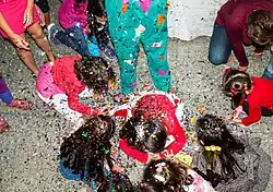 Children playing in a sweets piñata