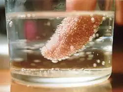 Placing an object (such as a person's index finger, shown here) in a carbonated beverage such as champagne provides nucleation sites, thus speeding the release of bubbles.