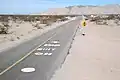Road markings south of the dip with the vado to the north beyond on Fed.&nbsp;5.[clarification needed]