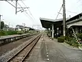 A view of the platforms and tracks. Note what appears to be the trackbed of a former track next to the platform to the left.