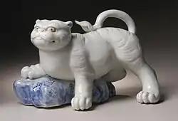 Okimono figurine in the form of a tiger climbing onto a rock, 19th century