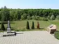 Original Soviet monument (on the left) on the killing site