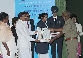 Excise Inspector Shri SP Singh (right) receiving Presidential Certificate of Appreciation (2013).[4]