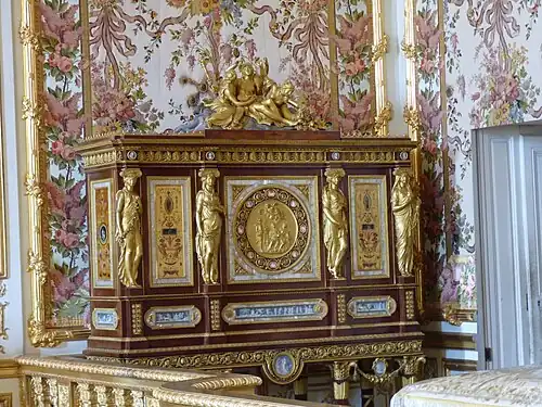 Louis XVI style jewelry locket of Marie-Antoinette, by Ferdinand Schwerdfeger, 1787, mahogany, mother-of-pearl inlays, paintings under glass, porcelain plate, and gilded bronzes, Chambre de la Reine, Palace of Versailles, Versailles, France[27]