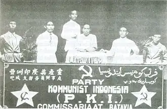 Six men behind a banner