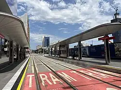 Photo of the Parramatta Square light rail stop with the under development metro station to the right.