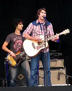 Murray playing a guitar on stage in 2006