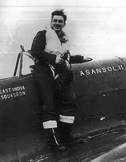 A United States Army Air Forces pilot sits on the aircraft nicknamed "Asanol II", belonging to the East India Squadron, stationed at Ningha Airfield near Asansol, West Bengal, during World War II. Likely photographed around 1943–45.