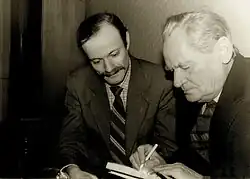 Chichibabin (right) autographs his book for Grigory Hansburg in the National Union of Composers of Ukraine, 4 March 1992