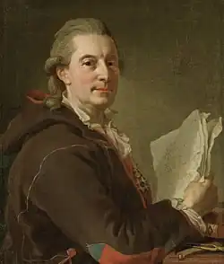 A man in his late 50s wearing a powdered 18th-century style wig. His body is facing to the right. His face has a resolute expression and is turned toward the viewer. His right arm is propped on a table with plotting tools and a book at the bottom of the painting and is holding up several white sheets of paper. He is wearing a large jacket or coat in a purple nuance with a red lingin and with red and blue designs on the sleeves and small of the back. The jacket is in the traditional style of the Sami people of northern Scandinavia.