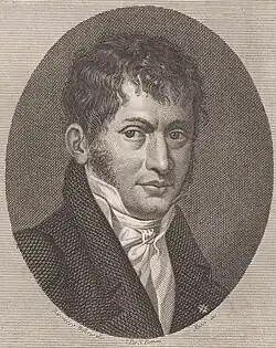 A young man in eighteenth-century formal dress, with untidy dark hair and sideburns.