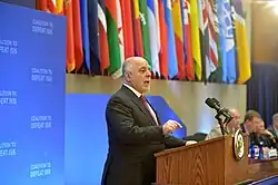 Speaker standing at a podium in front of a microphone