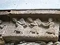 Workers transport blocks of stone.