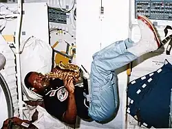Ronald McNair plays a saxophone in space.