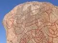 Endless serpent knot at top of stone
