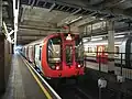 A District line S7 Stock train on bay platform 3 for the shuttle service to Olympia.