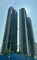 Tall residential building complex with three towers.